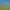 Eine Hand hält einen Topf mit süßer "Alélor"-Senf vor einem Feld gelber Blumen unter einem blauen Himmel